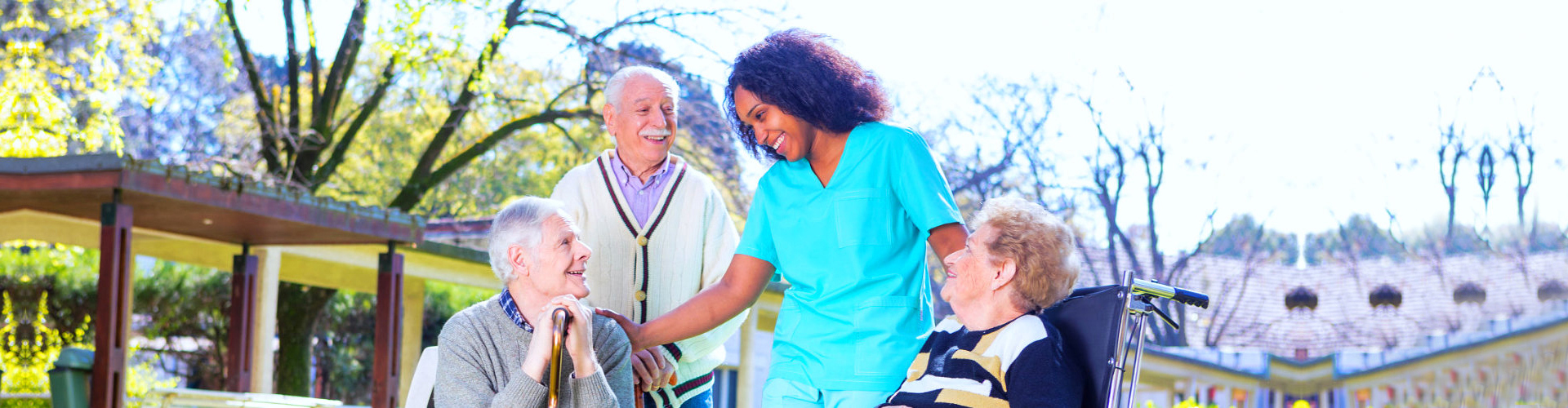 female aide with three elderly smiling